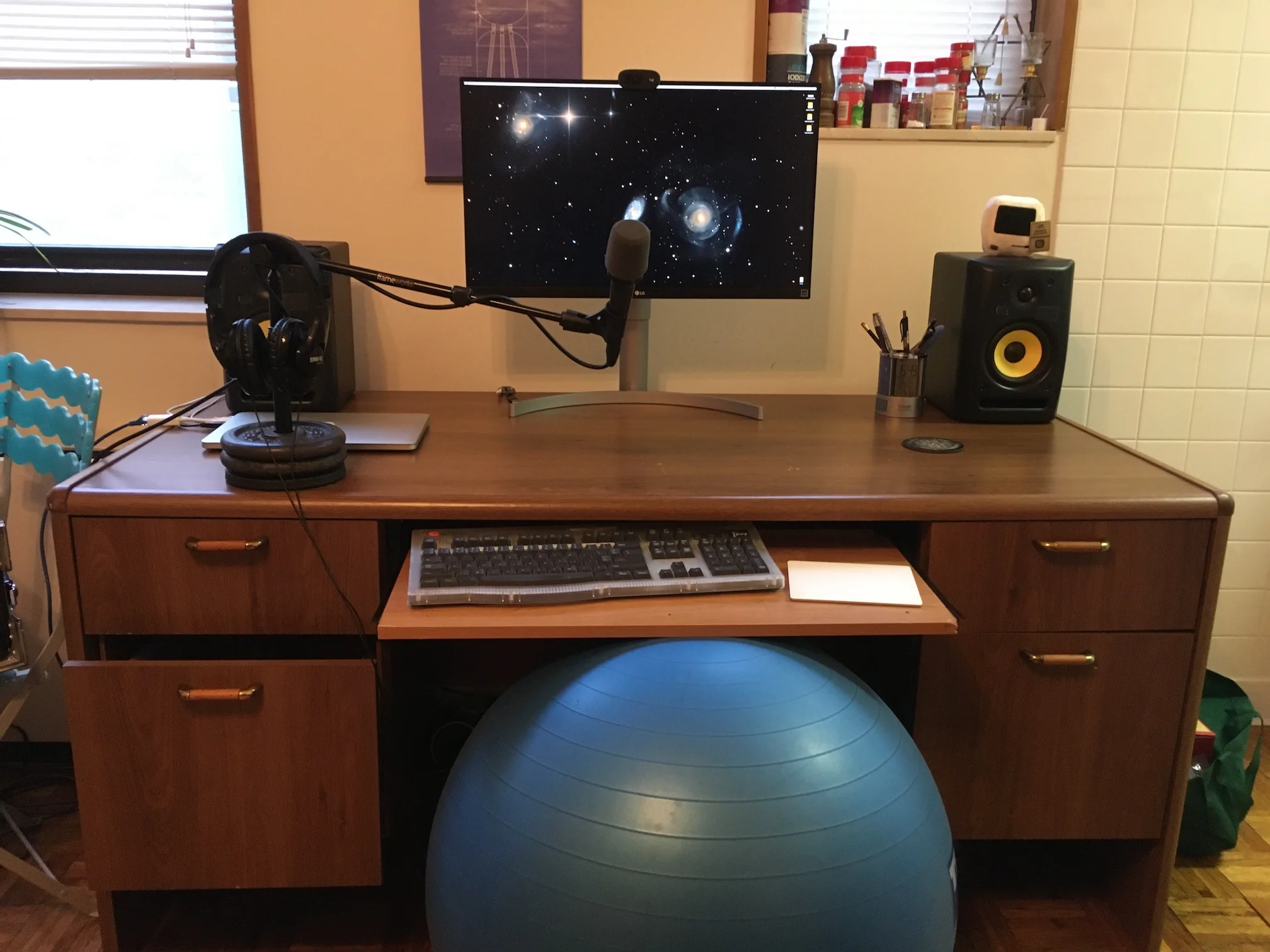desk with mic, headphones, and speakers
